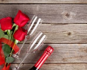 Roses and champagne glasses on wood slats